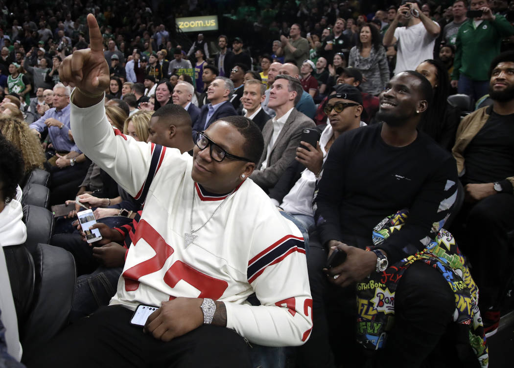 New England Patriots football player Trent Brown (77) acknowledges the fans as the Patriots' Super Bowl victory is honored during a break in an NBA basketball game between the Boston Celtics and t ...