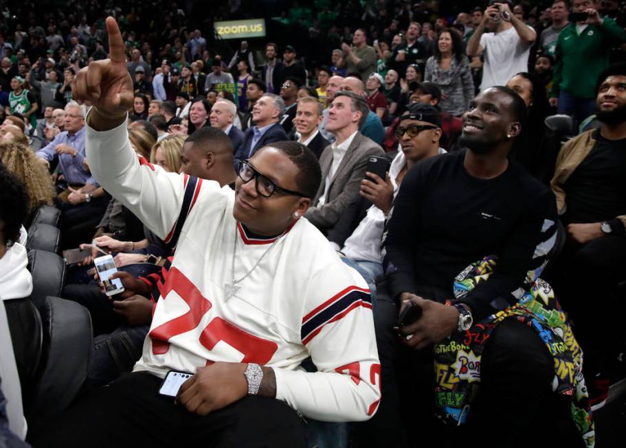 New England Patriots football player Trent Brown (77) acknowledges the fans as the Patriots' Super Bowl victory is honored during a break in an NBA basketball game between the Boston Celtics and t ...