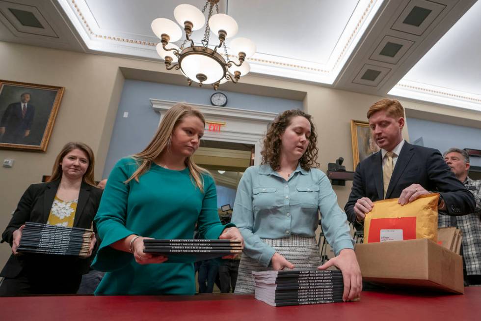 Office of Management and Budget staff delivers President Donald Trump's 2020 budget to the House Budget Committee on Capitol Hill in Washington, Monday, March 11, 2019. (J. Scott Applewhite/AP)