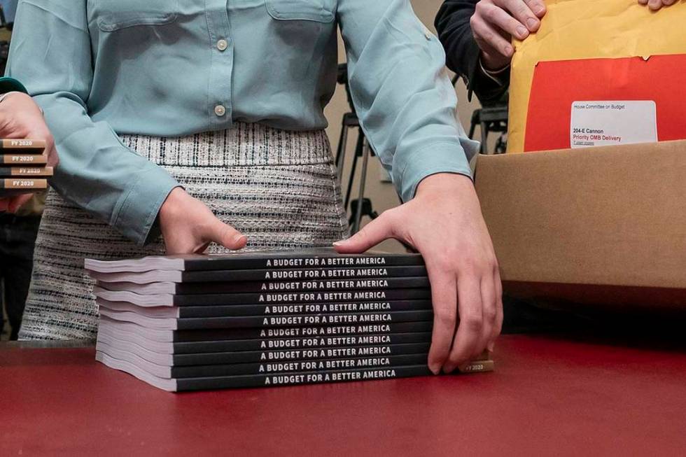 Office of Management and Budget staff delivers President Donald Trump's 2020 budget outline to the House Budget Committee on Capitol Hill in Washington, Monday, March 11, 2019. (J. Scott Applewhit ...