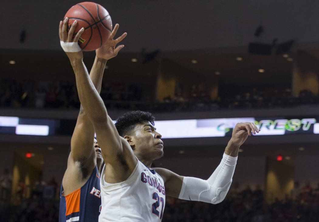 Gonzaga junior forward Rui Hachimura (21) drives past Pepperdine senior guard Eric Cooper Jr. (21) in the first half during the West Coast Conference semifinal game on Monday, March 11, 2019, at O ...