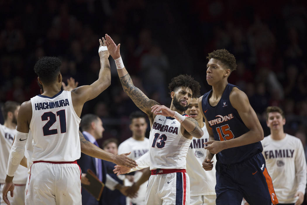 Gonzaga senior guard Josh Perkins (13) celebrates with junior forward Rui Hachimura (21) in the second half during their West Coast Conference semifinal game with Pepperdine on Monday, March 11, 2 ...