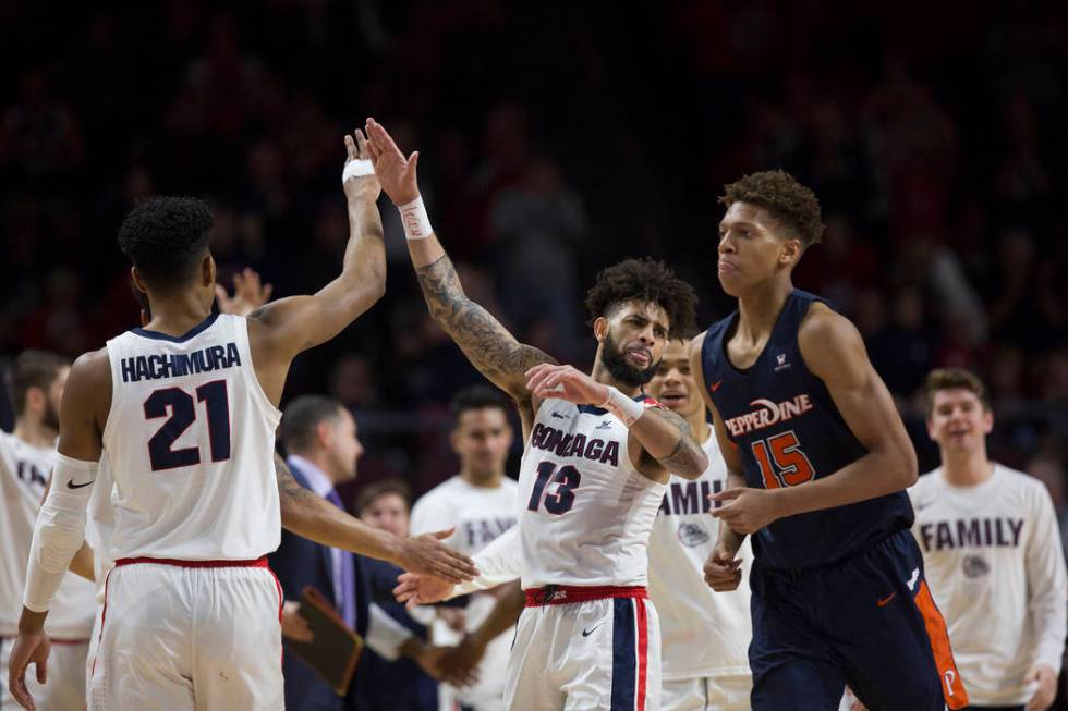 Gonzaga senior guard Josh Perkins (13) celebrates with junior forward Rui Hachimura (21) in the second half during their West Coast Conference semifinal game with Pepperdine on Monday, March 11, 2 ...