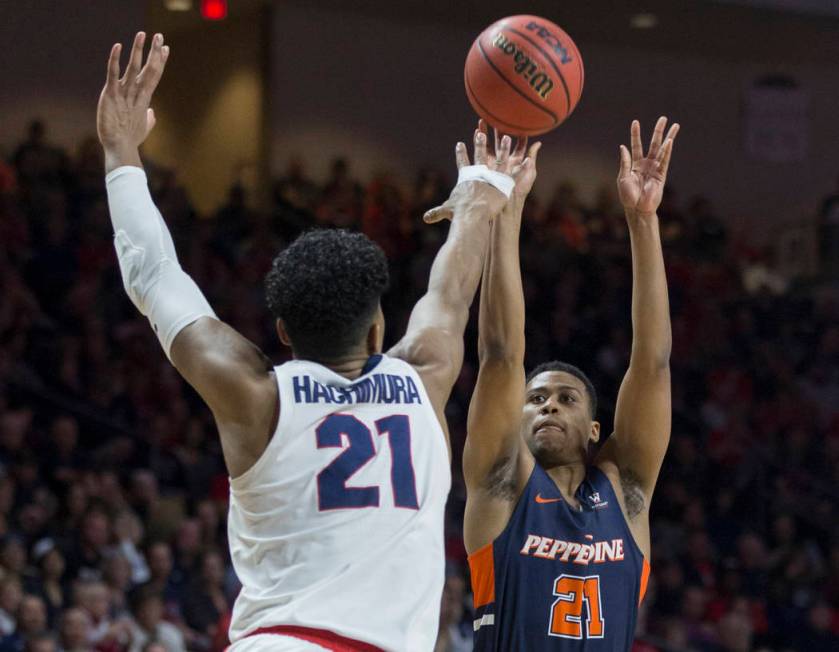 Pepperdine senior guard Eric Cooper Jr. (21) shoots over Gonzaga junior forward Rui Hachimura (21) in the second half during the West Coast Conference semifinal game on Monday, March 11, 2019, at ...