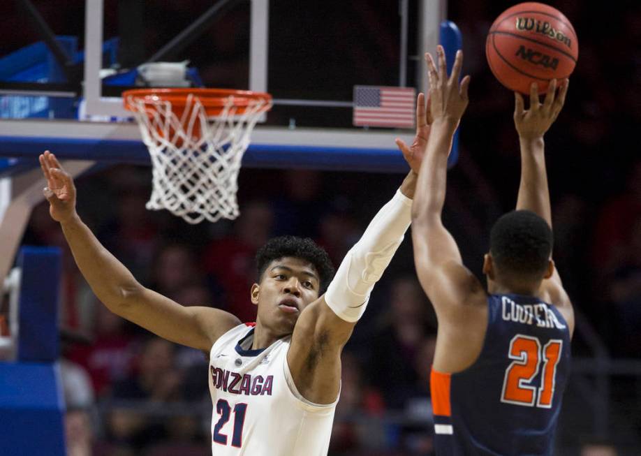 Gonzaga junior forward Rui Hachimura (21) extends to block the shot of Pepperdine senior guard Eric Cooper Jr. (21) in the first half during the West Coast Conference semifinal game on Monday, Mar ...