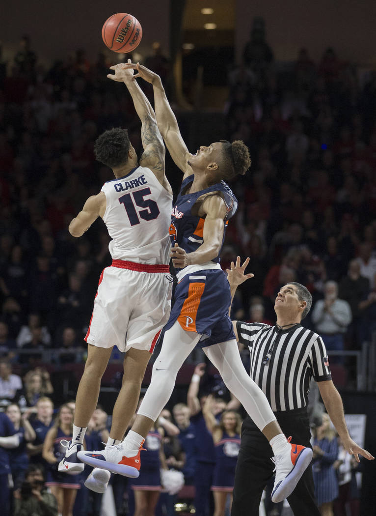 Gonzaga junior forward Brandon Clarke (15) leaps for the opening tip with Pepperdine freshman center Victor Ohia Obioha (34) in the first half during the West Coast Conference semifinal game on Mo ...