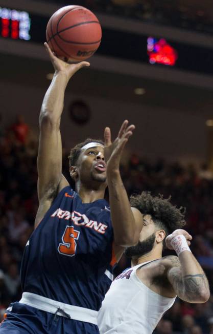 Pepperdine sophomore guard Jade' Smith (5) shoots a corner jump shot over Gonzaga senior guard Josh Perkins (13) in the second half during the West Coast Conference semifinal game on Monday, March ...