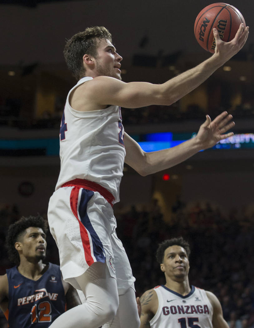 Gonzaga sophomore forward Corey Kispert (24) drives past Pepperdine senior forward Darnell Dunn (12) in the first half during the West Coast Conference semifinal game on Monday, March 11, 2019, at ...