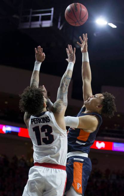 Pepperdine sophomore guard Colbey Ross (4) shoots over Gonzaga senior guard Josh Perkins (13) in the second half during the West Coast Conference semifinal game on Monday, March 11, 2019, at Orlea ...