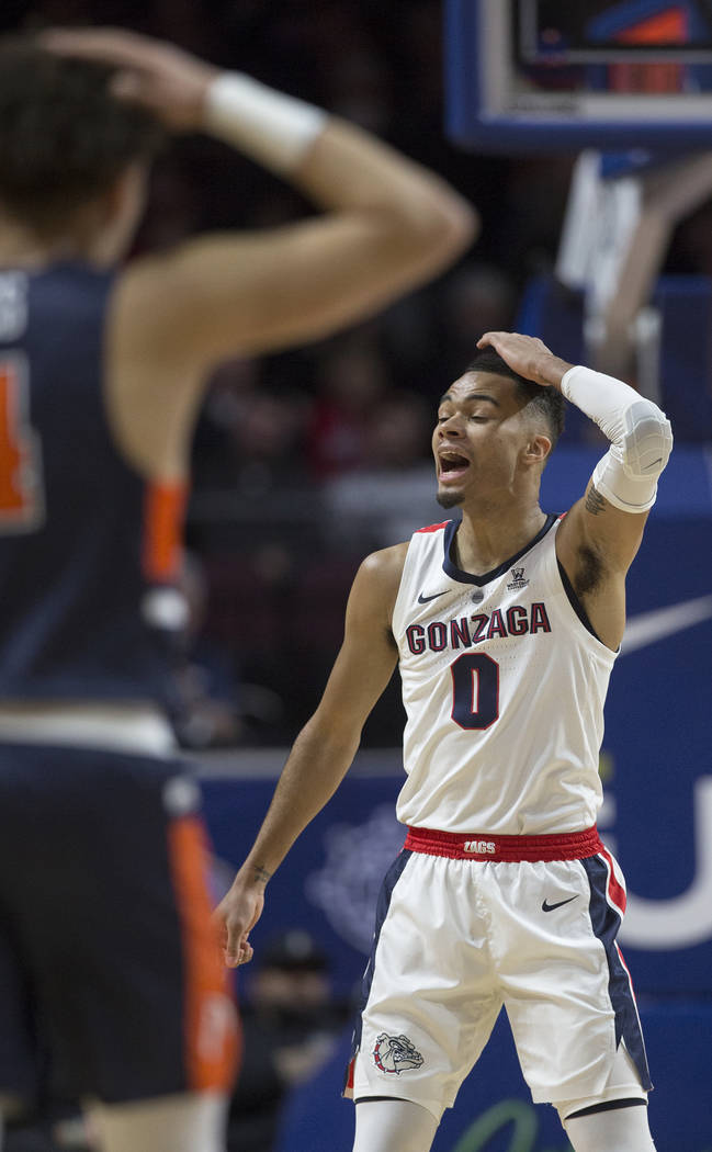 Gonzaga senior guard Geno Crandall (0) and Pepperdine sophomore guard Colbey Ross (4) both call out plays in the first half during the West Coast Conference semifinal game on Monday, March 11, 201 ...