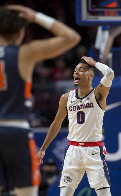 Gonzaga senior guard Geno Crandall (0) and Pepperdine sophomore guard Colbey Ross (4) both call out plays in the first half during the West Coast Conference semifinal game on Monday, March 11, 201 ...