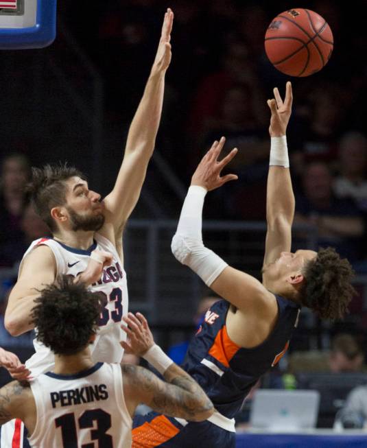 Pepperdine sophomore guard Colbey Ross (4) shoots over Gonzaga junior forward Killian Tillie (33) in the first half during the West Coast Conference semifinal game on Monday, March 11, 2019, at Or ...