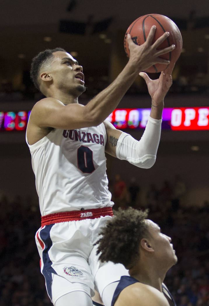 Gonzaga senior guard Geno Crandall (0) slices to the rim past Pepperdine sophomore guard Colbey Ross (4) in the first half during the West Coast Conference semifinal game on Monday, March 11, 2019 ...