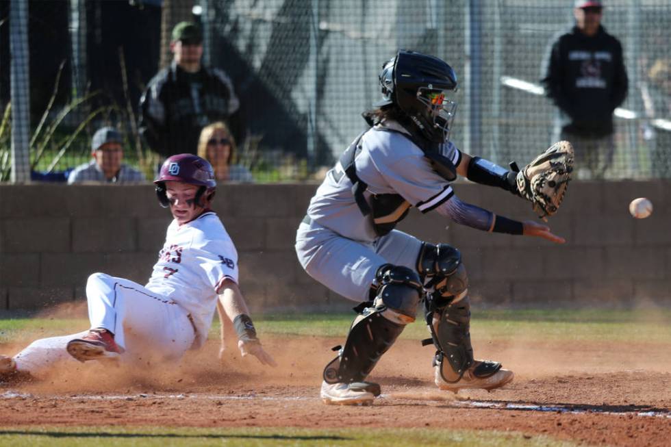 Desert Oasis' Colton Zobrist (7) slides home for a run against Palo Verde's Yuta Nakamura (52) in the baseball game at Desert Oasis High School in Las Vegas, Tuesday, March 12, 2019. Erik Verduzco ...