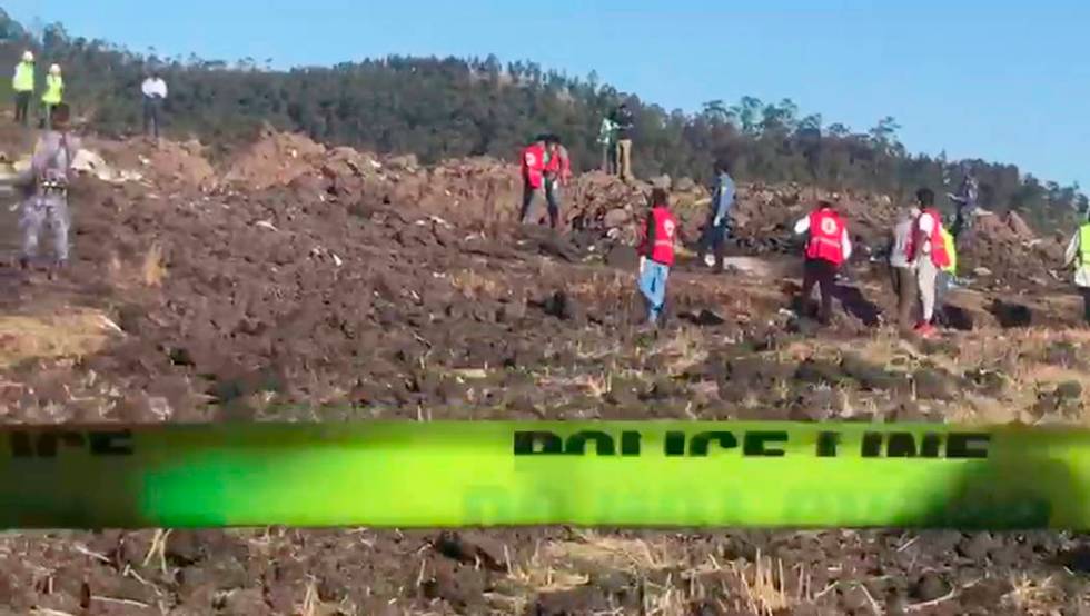 In this image taken from video, rescuers search through wreckage at the scene of an Ethiopian Airlines flight that crashed shortly after takeoff at Hejere near Bishoftu, or Debre Zeit, some 50 kil ...