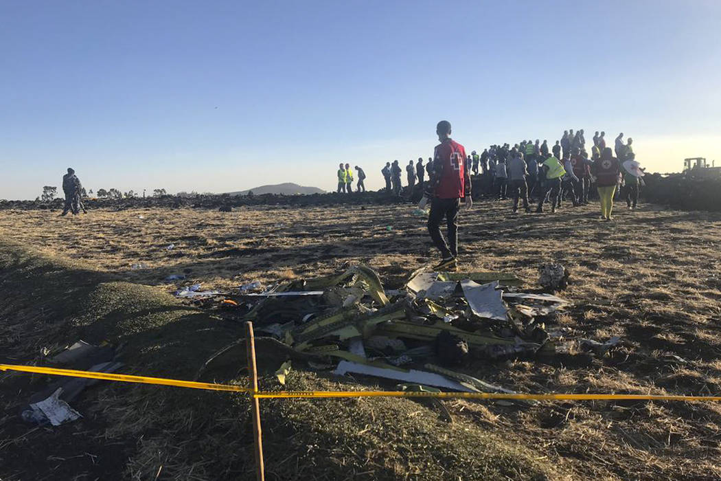 Rescuers search at the scene of an Ethiopian Airlines flight that crashed shortly after takeoff at the scene at Hejere near Bishoftu, or Debre Zeit, some 50 kilometers (31 miles) south of Addis Ab ...