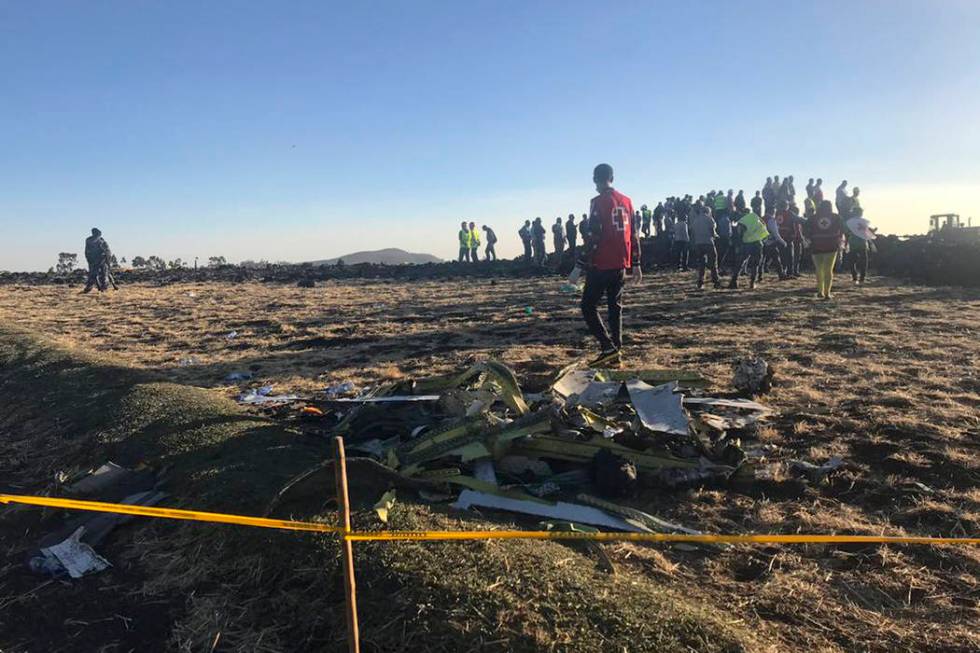 Rescuers search at the scene of an Ethiopian Airlines flight that crashed shortly after takeoff at the scene at Hejere near Bishoftu, or Debre Zeit, some 50 kilometers (31 miles) south of Addis Ab ...