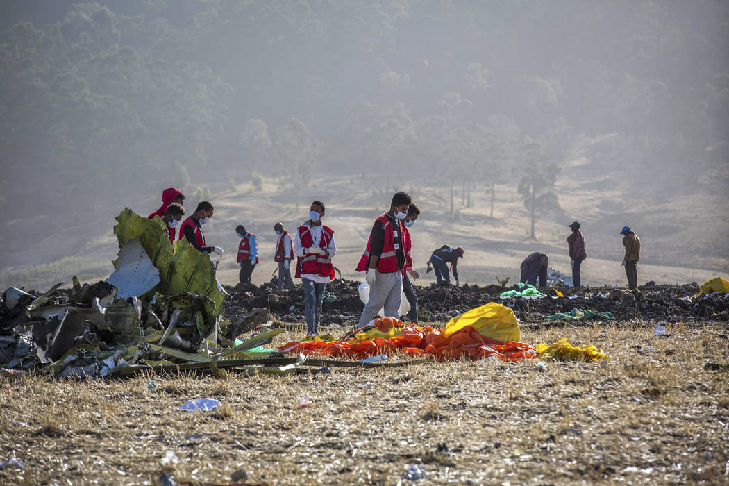 Rescuers work at the scene of an Ethiopian Airlines flight crash near Bishoftu, or Debre Zeit, south of Addis Ababa, Ethiopia, Monday, March 11, 2019. A spokesman says Ethiopian Airlines has grou ...