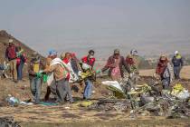 Rescuers work at the scene of an Ethiopian Airlines flight crash near Bishoftu, or Debre Zeit, south of Addis Ababa, Ethiopia, Monday, March 11, 2019. A spokesman says Ethiopian Airlines has grou ...