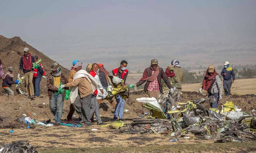 Rescuers work at the scene of an Ethiopian Airlines flight crash near Bishoftu, or Debre Zeit, south of Addis Ababa, Ethiopia, Monday, March 11, 2019. A spokesman says Ethiopian Airlines has grou ...