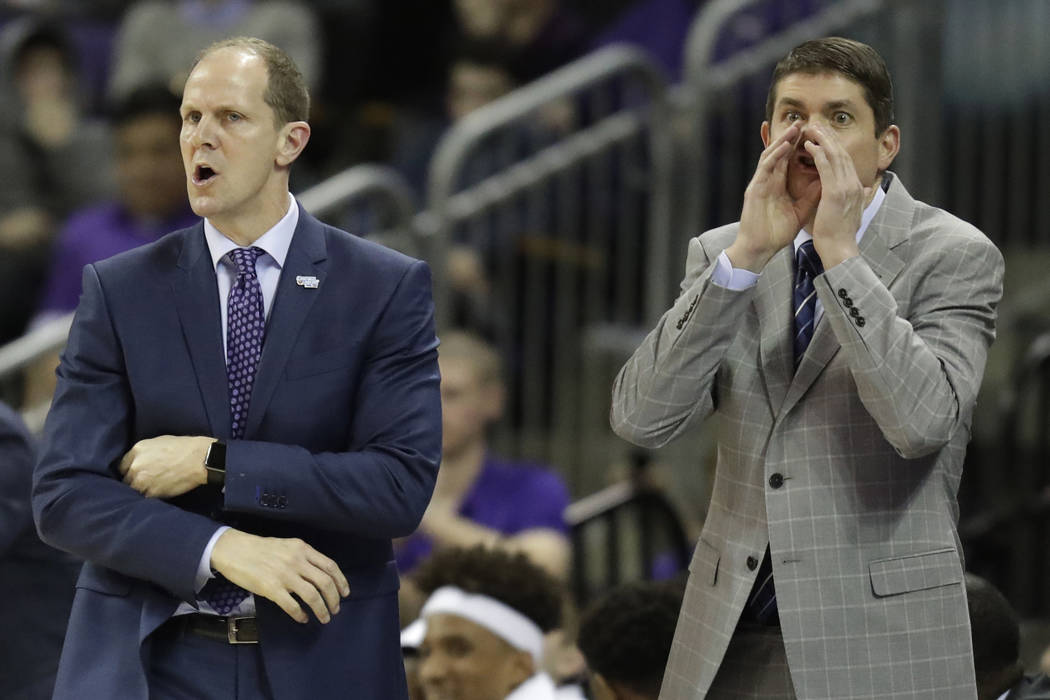 In this Sunday, Jan. 28, 2018 photo, Washington head coach Mike Hopkins, left, calls to his team along with assistant coach Dave Rice, right,, during the first half of an NCAA college basketball g ...