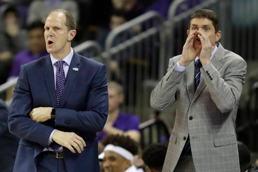 In this Sunday, Jan. 28, 2018 photo, Washington head coach Mike Hopkins, left, calls to his team along with assistant coach Dave Rice, right,, during the first half of an NCAA college basketball g ...