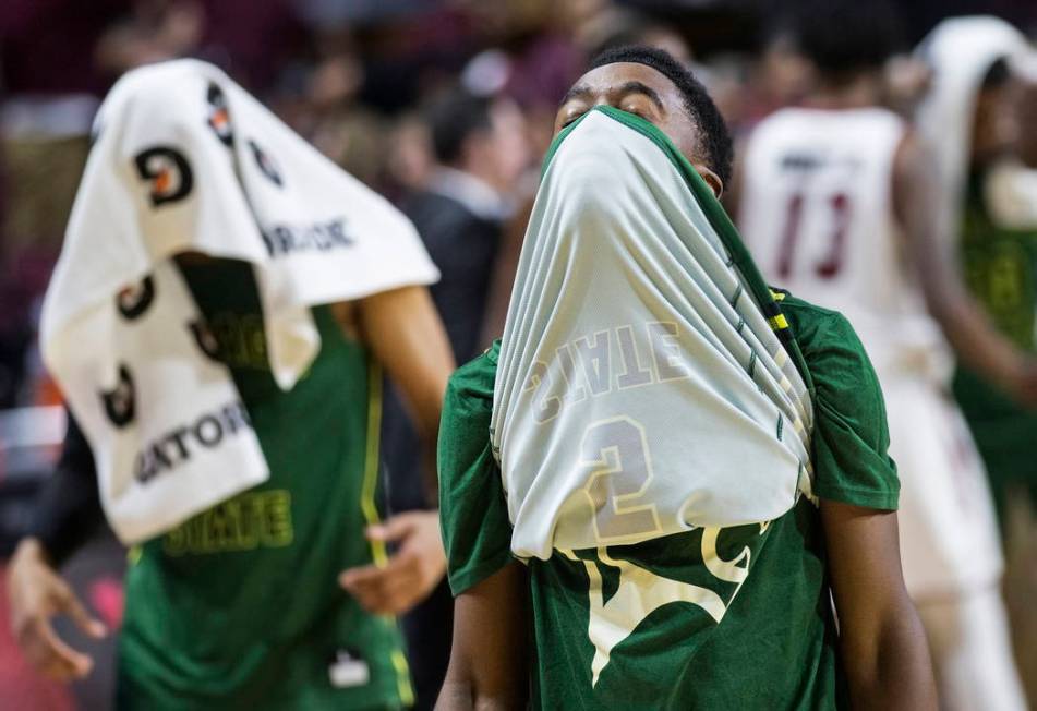 Chicago State senior guard Delshon Strickland (2) walks off the court with his face covered after the Cougars lost to New Mexico State 86-49 in the opening round of the Western Athletic Conference ...