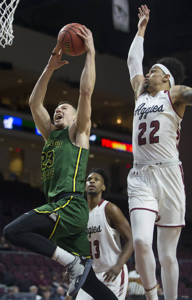 Chicago State junior forward Patrick Szpir (23) drives to the rim past New Mexico State senior forward Eli Chuha (22) in the first half of the opening round of the Western Athletic Conference tour ...