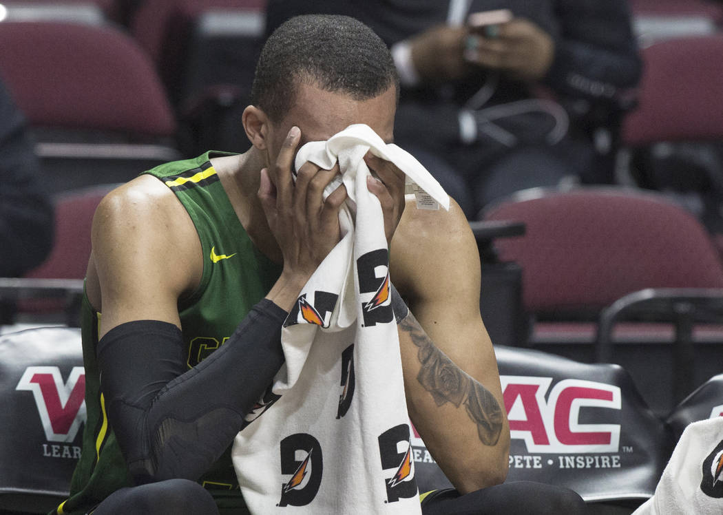 Chicago State senior guard Delshon Strickland (2) covers his face on the bench after the Cougars lost to New Mexico State 86-49 in the opening round of the Western Athletic Conference tournament ...