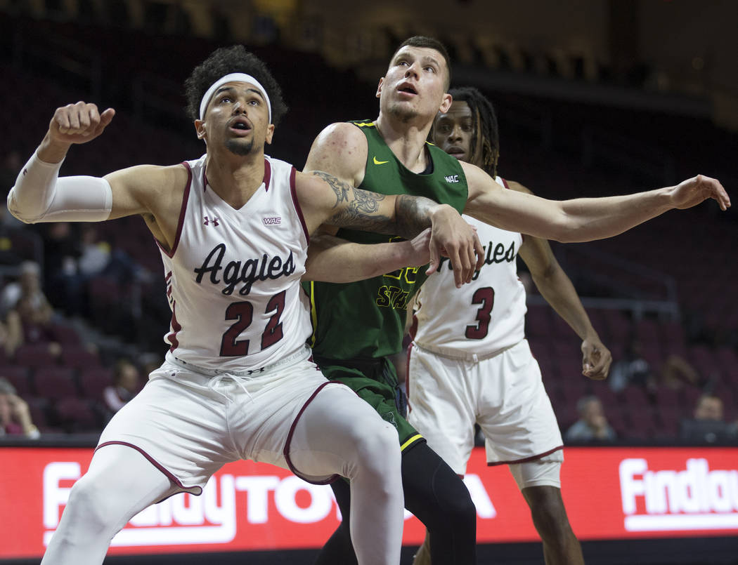 Chicago State junior forward Patrick Szpir (23) fights for position with New Mexico State senior forward Eli Chuha (22) and junior guard Terrell Brown (3) in the second half of the opening round o ...