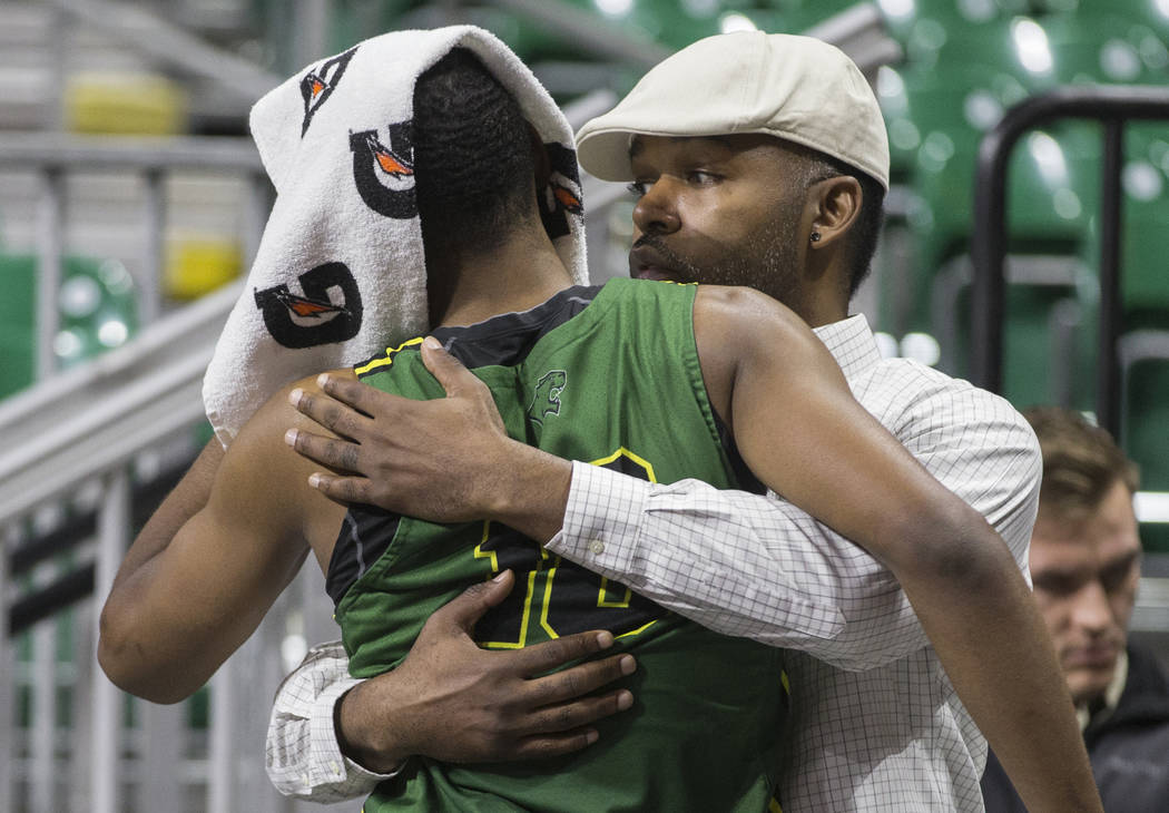 Chicago State senior guard Anthony Harris (10) gets a hug from a family member after the Cougars lost to New Mexico State 86-49 in the opening round of the Western Athletic Conference tournament o ...
