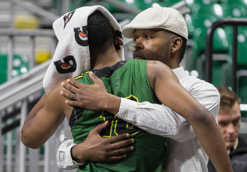 Chicago State senior guard Anthony Harris (10) gets a hug from a family member after the Cougars lost to New Mexico State 86-49 in the opening round of the Western Athletic Conference tournament o ...