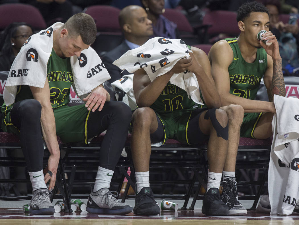 Chicago State junior forward Patrick Szpir (23), senior guard Anthony Harris (10) and junior forward Patrick Szpir (23) sit dejected on the bench as time winds down on a 86-49 loss to New Mexico S ...