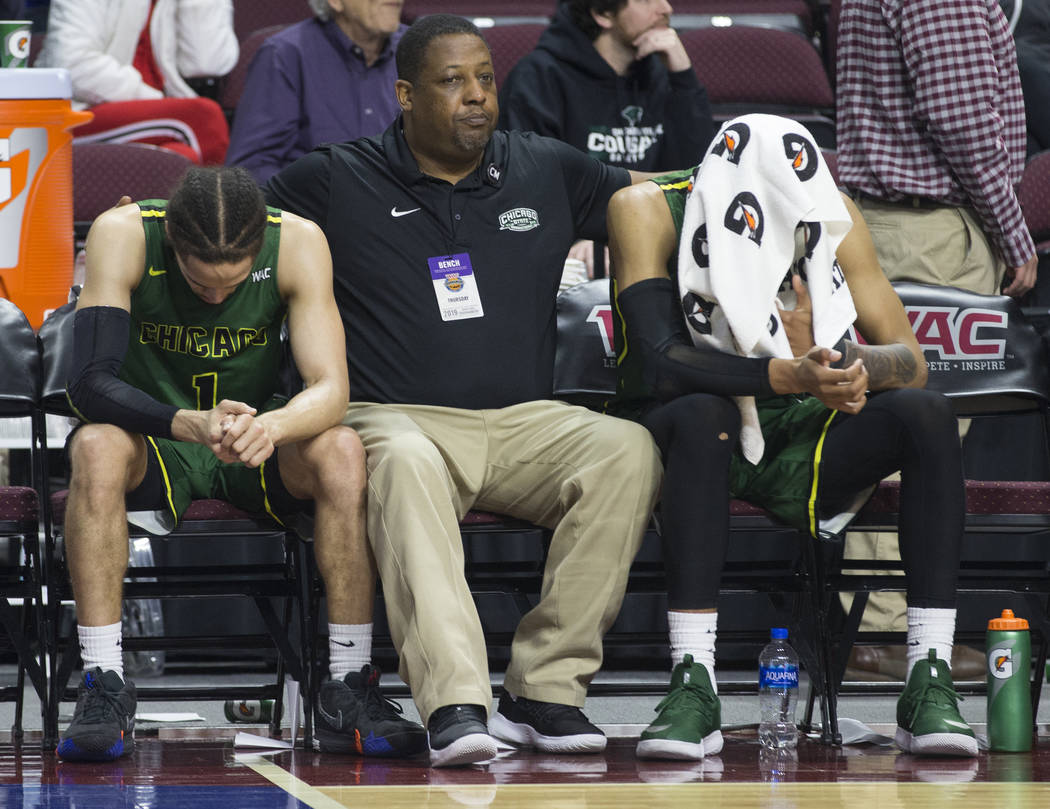 Chicago State senior guard Rob Shaw, left, and Chicago State senior guard Delshon Strickland, right, sit dejected on the bench as time winds down on a 86-49 loss to New Mexico State in the opening ...
