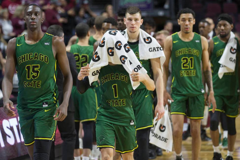 Chicago State senior guard Rob Shaw (1) walks off the court with his face covered, along with teammate Noah Bigirumwami (15), after the Cougars lost to New Mexico State 86-49 in the opening round ...