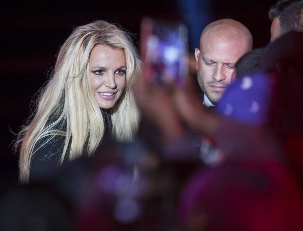 Britney Spears signs autographs during an event to announce her new residency at The Park Theater at Park MGM on Thursday, Oct. 18, 2018, outside T-Mobile Arena, in Las Vegas. (Benjamin Hager/Las ...