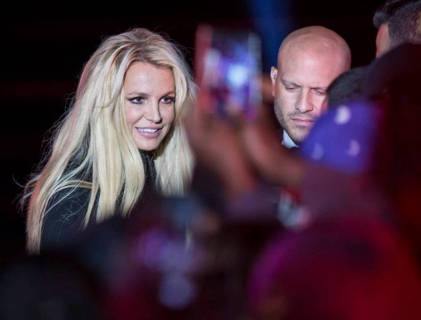 Britney Spears signs autographs during an event to announce her new residency at The Park Theater at Park MGM on Thursday, Oct. 18, 2018, outside T-Mobile Arena, in Las Vegas. (Benjamin Hager/Las ...