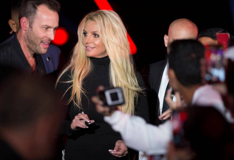 Britney Spears signs autographs during an event to announce her new residency at The Park Theater at Park MGM on Thursday, Oct. 18, 2018, outside T-Mobile Arena, in Las Vegas. (Benjamin Hager/Las ...