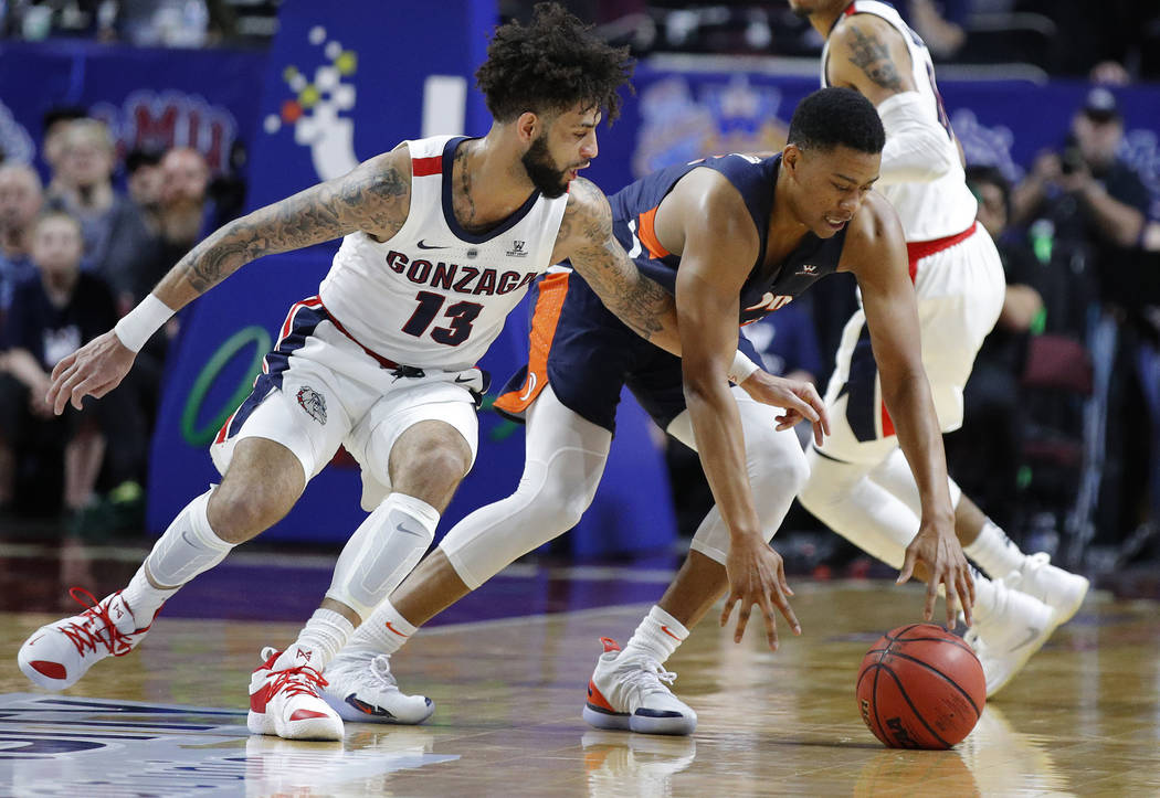 Gonzaga's Josh Perkins (13) tries to steal the ball from Pepperdine's Eric Cooper Jr. during the first half of an NCAA semifinal college basketball game at the West Coast Conference tournament, Mo ...