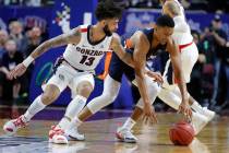 Gonzaga's Josh Perkins (13) tries to steal the ball from Pepperdine's Eric Cooper Jr. during the first half of an NCAA semifinal college basketball game at the West Coast Conference tournament, Mo ...