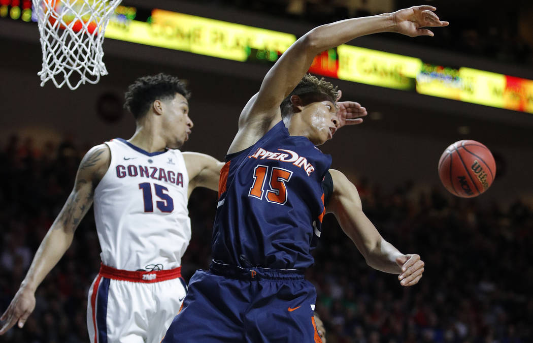 Gonzaga's Brandon Clarke, left, fouls Pepperdine's Kessler Edwards during the second half of an NCAA semifinal college basketball game at the West Coast Conference tournament, Monday, March 11, 20 ...