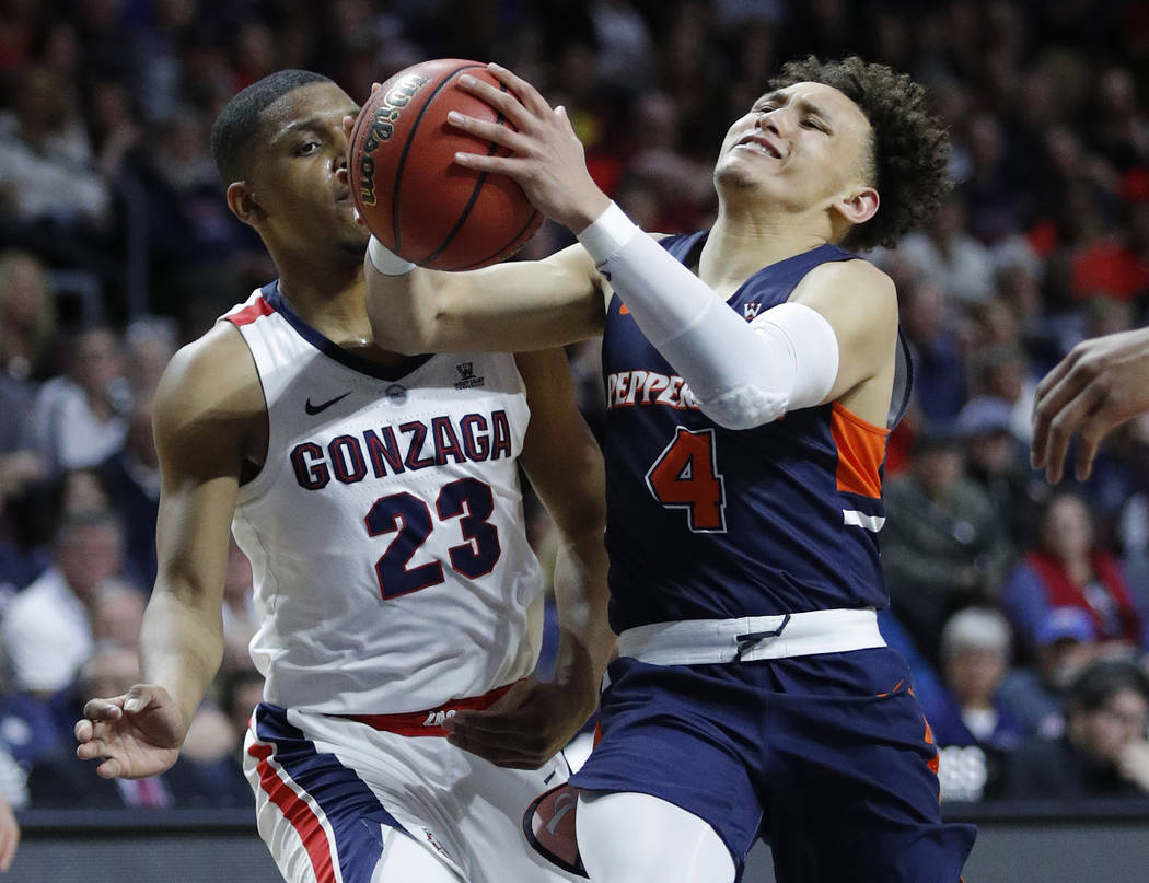Pepperdine's Colbey Ross (4) drives around Gonzaga's Zach Norvell Jr. during the second half of an NCAA semifinal college basketball game at the West Coast Conference tournament, Monday, March 11, ...