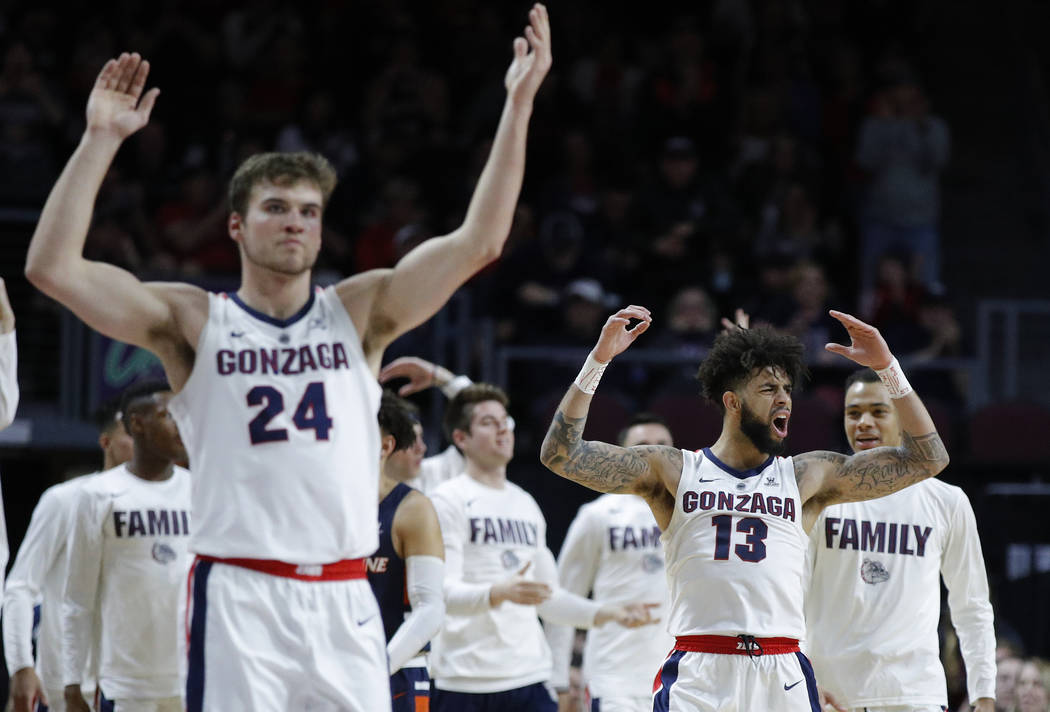 Gonzaga's Josh Perkins (13) and Corey Kispert (24) celebrate after a play against Pepperdine during the second half of an NCAA semifinal college basketball game at the West Coast Conference tourna ...