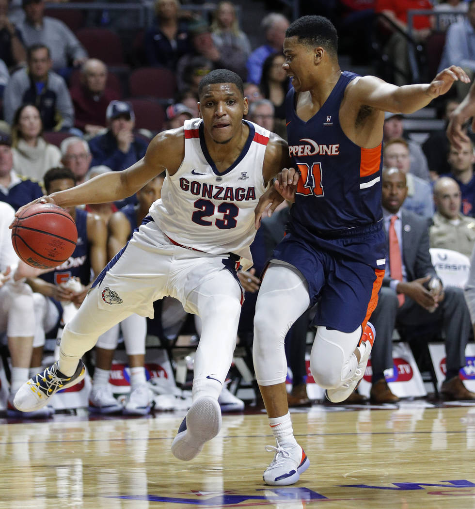 Gonzaga's Zach Norvell Jr., left, drives around Pepperdine's Eric Cooper Jr. during the first half of an NCAA semifinal college basketball game at the West Coast Conference tournament, Monday, Mar ...