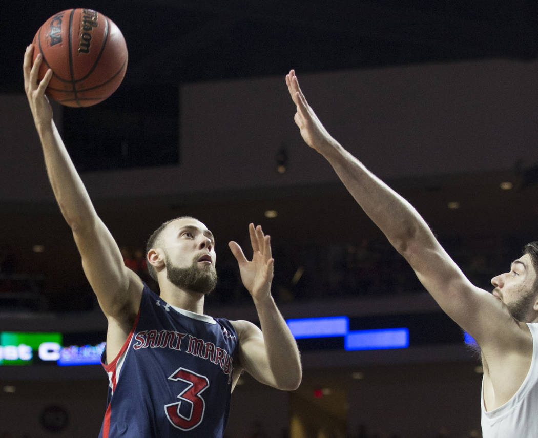 St. Mary's junior guard Jordan Ford (3) slices to the rim over Gonzaga junior forward Killian Tillie (33) in the second half during the West Coast Conference finals game on Tuesday, March 12, 2019 ...