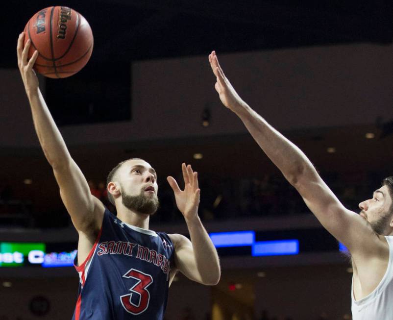 St. Mary's junior guard Jordan Ford (3) slices to the rim over Gonzaga junior forward Killian Tillie (33) in the second half during the West Coast Conference finals game on Tuesday, March 12, 2019 ...