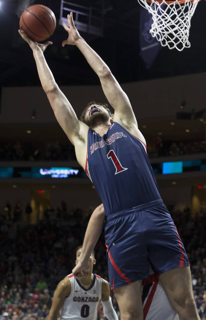 St. Mary's senior center Jordan Hunter (1) grabs a rebound over Gonzaga senior guard Geno Crandall (0) in the second half during the West Coast Conference finals game on Tuesday, March 12, 2019, a ...