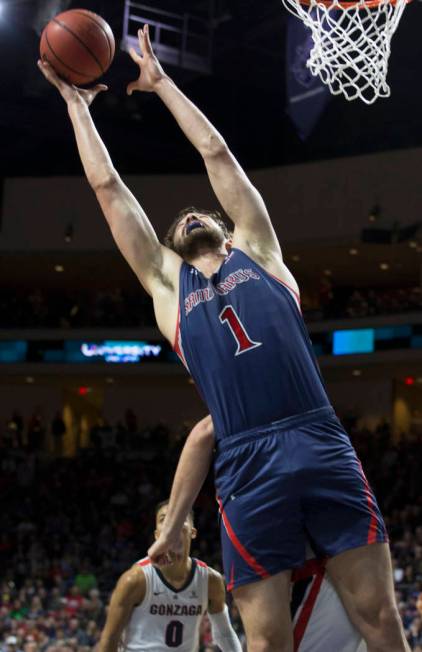 St. Mary's senior center Jordan Hunter (1) grabs a rebound over Gonzaga senior guard Geno Crandall (0) in the second half during the West Coast Conference finals game on Tuesday, March 12, 2019, a ...