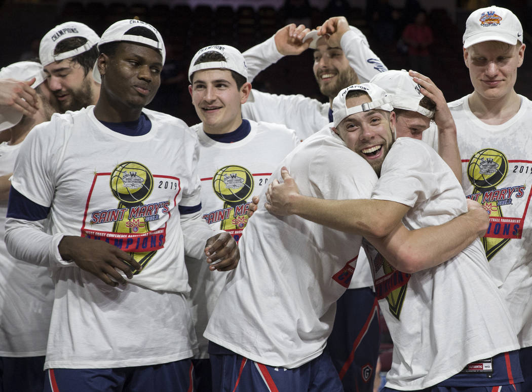 St. Mary's junior guard Jordan Ford, right, gets a big hug after the Gaels upset Gonzaga 60-47 to win the West Coast Conference championship on Tuesday, March 12, 2019, at Orleans Arena, in Las Ve ...