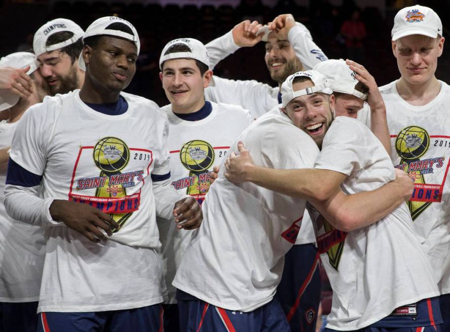 St. Mary's junior guard Jordan Ford, right, gets a big hug after the Gaels upset Gonzaga 60-47 to win the West Coast Conference championship on Tuesday, March 12, 2019, at Orleans Arena, in Las Ve ...